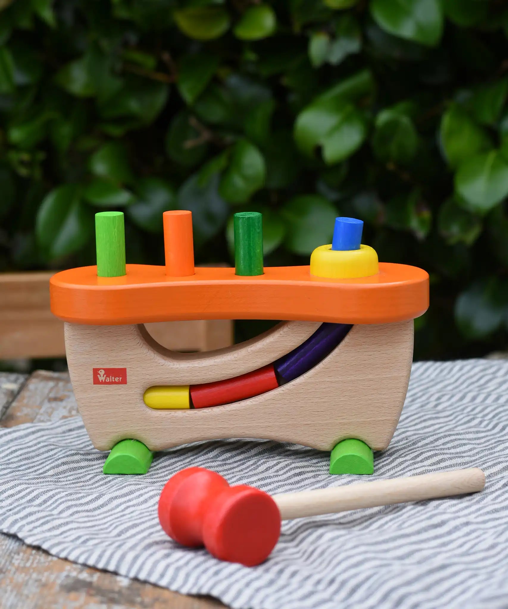 Nic wooden pounding bench hammering toy placed on a table outdoors.