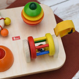 Close up of the rattling tree top and roller attached to the Nic Wooden Baby Game busy Board with 4 four activities.