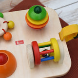 Close up of the Nic Wooden Baby Game busy Board with 4 four activities. Spin the carousel, squeaky button, rattling tree top and roller.