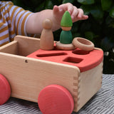 Nic wooden carriage shape sorter pull along toy with Grapat toys placed on top, Nins, coins and rings.