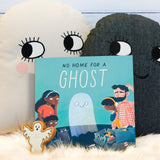 No Home for a Ghost kids book from Owlet Press on a fluffy blanket next to some Roommate Ghost cushions
