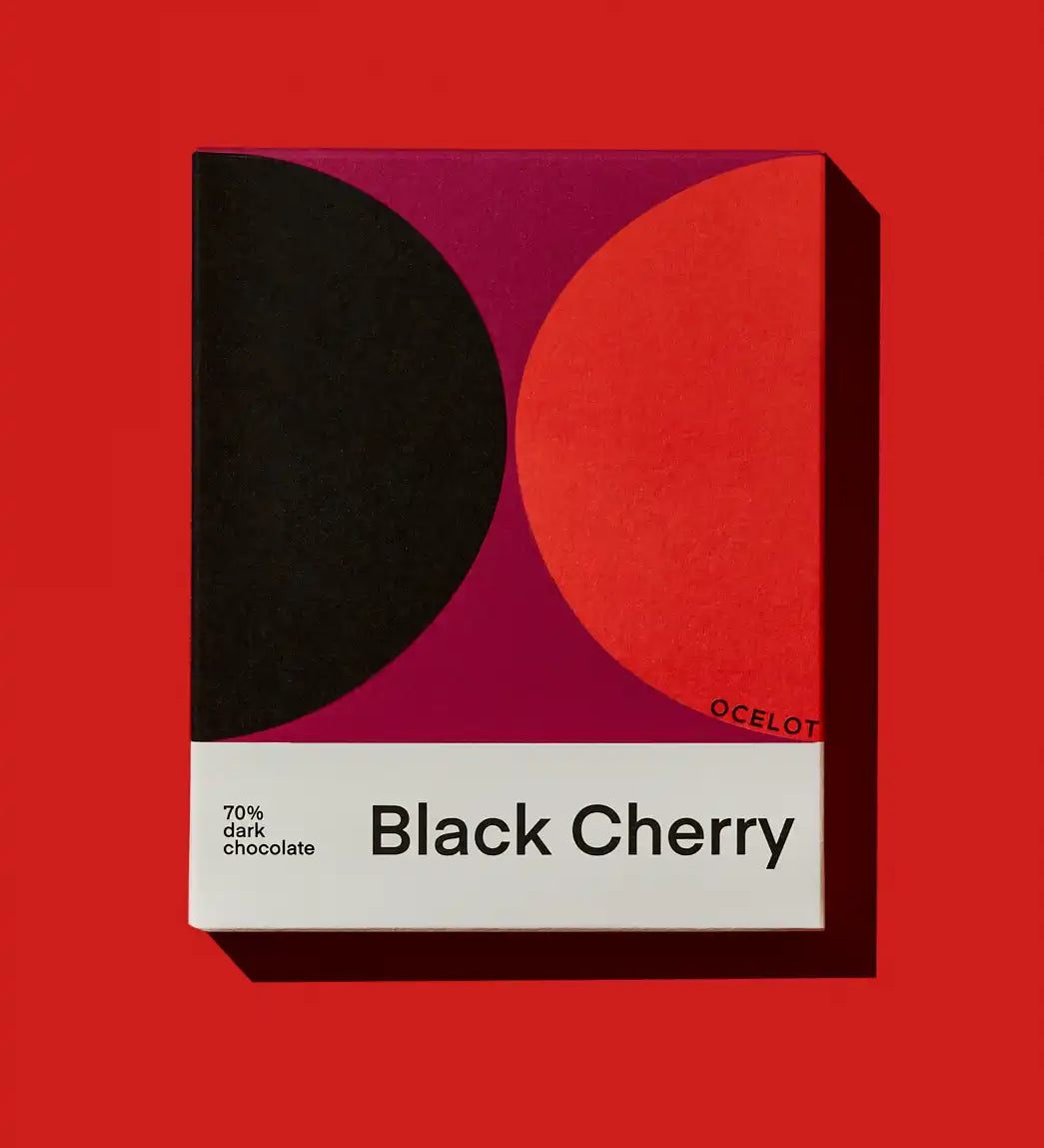 Ocelot Black Cherry Organic 70% Dark Chocolate in a box featuring a bold geometric design.