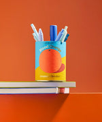 Ocelot Blood Orange Organic Drinking Chocolate tin repurposed and used as a pen pot.