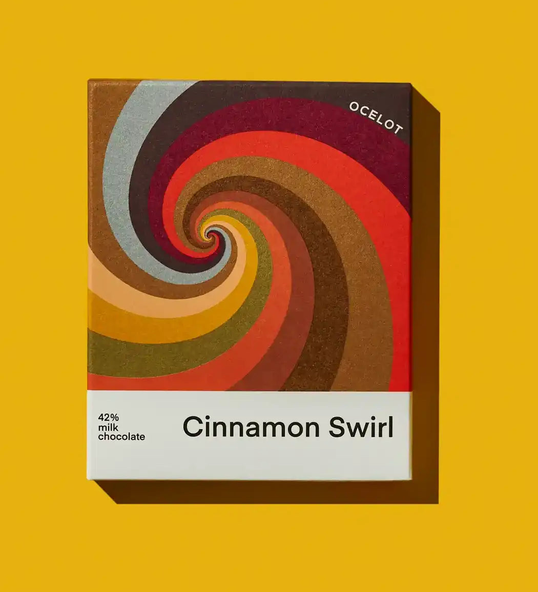 Ocelot Cinnamon Swirl Organic 55% Dark Milk Chocolate in a box featuring a geometric design.