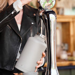 Close up of lady pouring ale into a One Green Bottle Epic 2L Thunder canteen