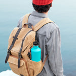 Man wearing a rucksack with a One Green Bottle 800ml metal water bottle in the side pocket
