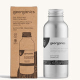 A bottle of the Georganics activated charcoal oil pulling mouthwash with the box