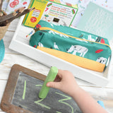 Child using a green Okonorm chalk to trace over numbers drawn on a small chalkboard.