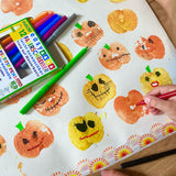 Child using the red pen from the OkoNorm 12 felt tip pens  to paint details on pumpkin prints.