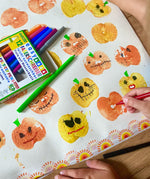 Child using the red pen from the OkoNorm 12 felt tip pens  to paint details on pumpkin prints.