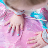 Child with his hand in pink coloured  OkoNorm non-toxic Finger Paints. 