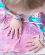 Child with his hand in pink coloured  OkoNorm non-toxic Finger Paints. 