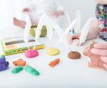 OkoNorm modelling clay used to create little bunny faces with feathers stuck on them in place of ears. 