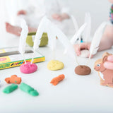 OkoNorm modelling clay used to create little bunny faces with feathers stuck on them in place of ears. 