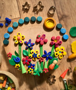 Flowers created using the OkoNorm play dough decorated with Grapat mandala pieces.