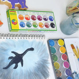 Watercolour dinosaur shadow painting created using the Okonorm 12 colour watercolour paints in a travel tin.