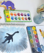 Watercolour dinosaur shadow painting created using the Okonorm 12 colour watercolour paints in a travel tin.