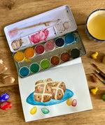 Watercolour hot cross buns painting created using the Okonorm 12 colour watercolour paints in a travel tin.