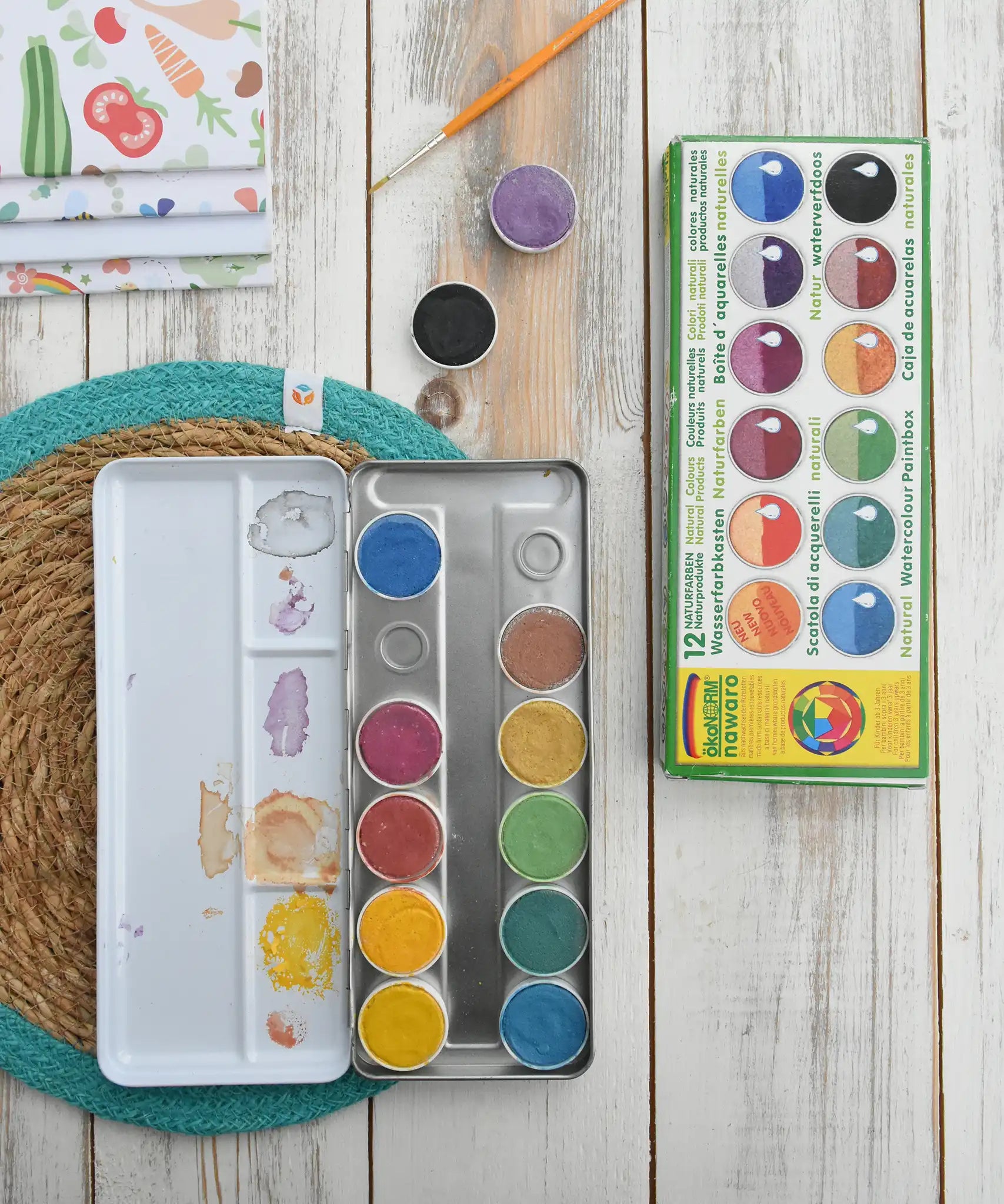 Okonorm 12 colour watercolour paints in a travel tin shown with some of the paint pods removed.