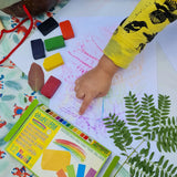 Children creating leaf rubbings with the Okonorm wax blocks from the 12 pack of rainbow colours.