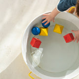 Oli & Carol X Bauhaus Movement Floating Geometric Blocks pictured floating in a metal tub full of water