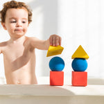 Child stacking the Oli & Carol X Bauhaus Movement Floating Geometric Blocks
