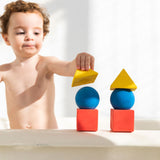 Child stacking the Oli & Carol X Bauhaus Movement Floating Geometric Blocks