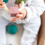 Baby chewing on the Oli & Carol X Bauhaus Movement Teething Ring in Pastel Colours
