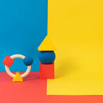 Oli & Carol X Bauhaus Movement teething ring and Floating Geometric Blocks pictured on a plain white background