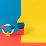 Oli & Carol X Bauhaus Movement teething ring and Floating Geometric Blocks pictured on a plain white background