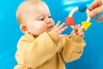 Side view of Oli & Carol X Bauhaus Movement Teething Ring pictured on a plain white background