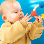 Side view of Oli & Carol X Bauhaus Movement Teething Ring pictured on a plain white background