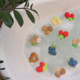 Oli and carol eco-friendly natural rubber forest fruit and nut baby teething toys floating in some bubbly bath water