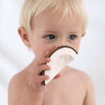 A child holding the Oli & Carol Coco The Coconut. 