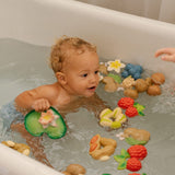 Child playing in a bath with the oli and carol natural rubber