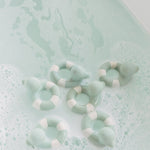 Oli & Carol Flo The Floatie Mint colour duck bath toys in a bubble bath