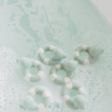 Oli & Carol Flo The Floatie Mint colour duck bath toys in a bubble bath