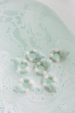 Oli & Carol Flo The Floatie Mint colour duck bath toys in a bubble bath