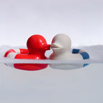 Oli & Carol red and whiet and blue Flo The Floatie Ducks in water