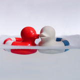 Oli & Carol red and whiet and blue Flo The Floatie Ducks in water