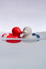 Oli & Carol red and whiet and blue Flo The Floatie Ducks in water