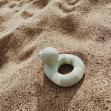 Oli & Carol Flo The Floatie Mint colour duck pictured on sand