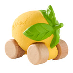 A child playing with the Oli & Carol 100% Natural Rubber Cars