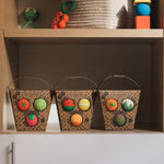 Three Packets of Oli & Carol Baby Sensory Balls, Fruit Salad, Veggie Salad and Veggie Soup placed on shelving with other Oli and Carol toys above them