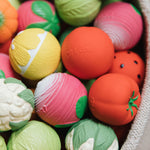 A collection of Oli & Carol fruit and vegetable baby sensory balls 