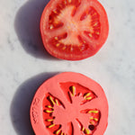 Oli & Carol Renato The Tomato pictured next to a slice of real tomato on a marble surface