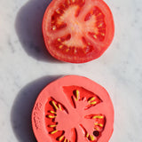 Oli & Carol Renato The Tomato pictured next to a slice of real tomato on a marble surface