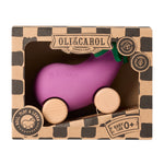 A child chewing on the Oli & Carol 100% Natural Rubber Emma the Eggplant Car