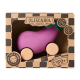 A child chewing on the Oli & Carol 100% Natural Rubber Emma the Eggplant Car