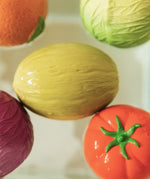 Five fruit and vegetable Oli & Carol 100% Natural Rubber Baby Sensory Balls floating in the bath